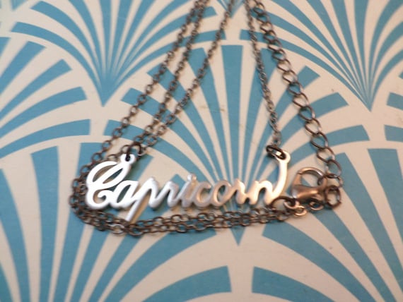 vintage 90's Capricorn written silver tone necklace