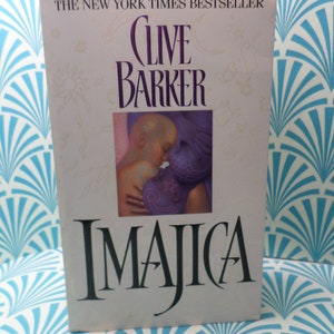 May include: A book cover with the title "Imajica" by Clive Barker. The cover features a painting of a woman and a child.