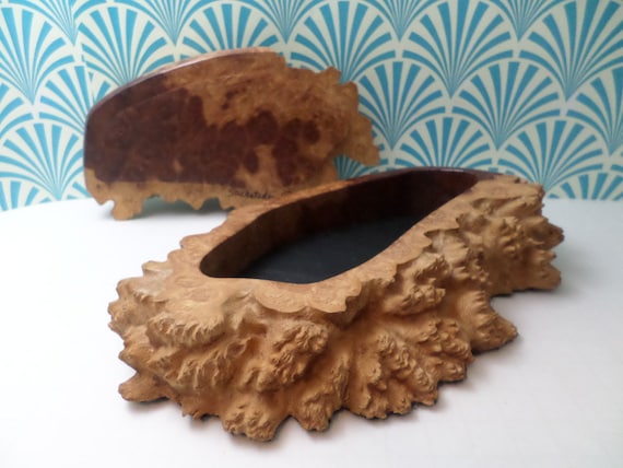 A signed, one-of-a-kind bird's-eye burl wood puzzle box — the rare figured grain makes every piece visually unrepeatable.