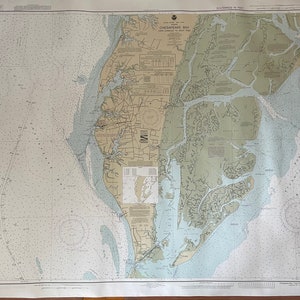 May include: A nautical chart of Chesapeake Bay, showing the waterways and islands of the bay. The chart is printed on a large sheet of paper and is in black and white.