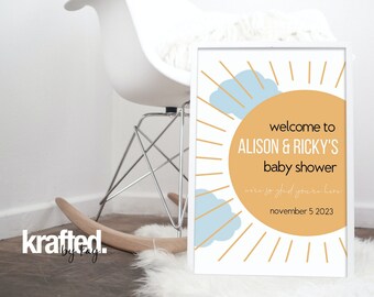 Könnte beinhalten: Ein weiß gerahmtes Schild mit einer gelben Sonne und blauen Wolken Grafik. Der Text auf dem Schild lautet "welcome to ALISON & RICKY'S baby shower we're so glad you're here november 5 2023".