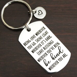 May include: Silver keychain with a tag that reads "Bring love wherever you go. Shine light wherever it's dark. Leave blessings wherever you've been. Be kind wherever you are."