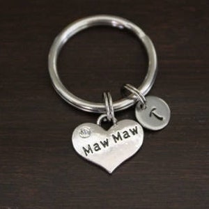 May include: Silver keychain with a heart charm that says "Maw Maw" and a small charm with the letter "T".