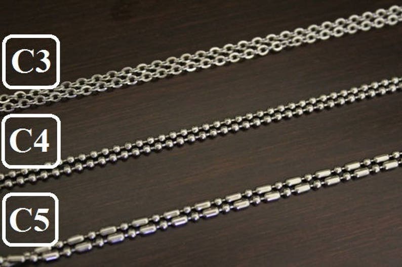May include: Three different types of silver chains, labeled C3, C4, and C5. The chains are laid out horizontally on a dark brown surface.