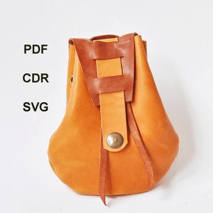 May include: A handcrafted, tan leather pouch with a brown leather flap and strap closure. The pouch has a rounded bottom and a rectangular flap secured with a metal button. The image also includes the text "PDF", "CDR", and "SVG".