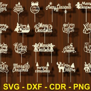 May include: A set of 16 digital cut files for a Christmas cake topper. The files include various designs with the text "Merry Christmas" in different fonts and styles. The designs feature snowflakes, stars, reindeer, angels, and other festive elements.