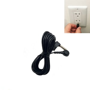 May include: Black electrical cord with a plug on one end and a prong on the other end. The cord is coiled up and ready to be used.