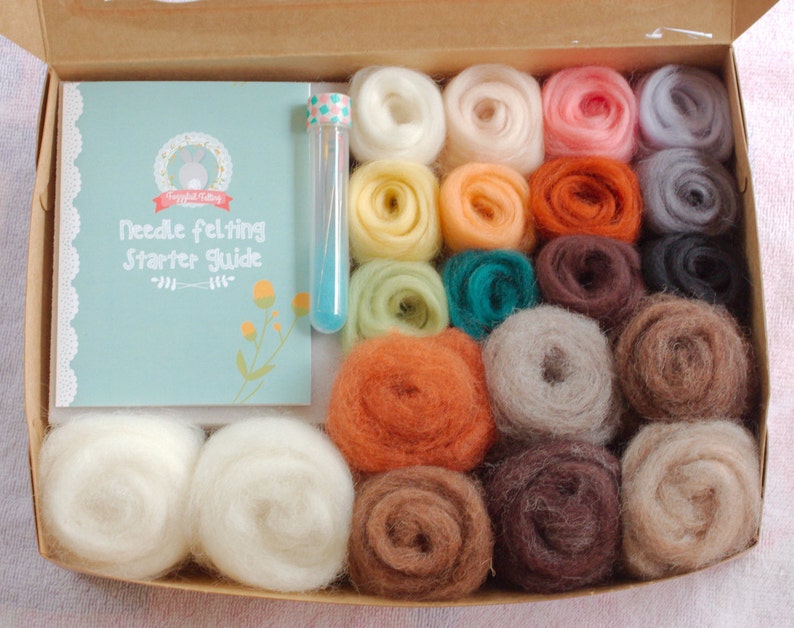 May include: A needle felting starter kit with a variety of colored wool fibers, a needle felting tool, and a guide booklet. The booklet has the title "Needle Felting Starter Guide".