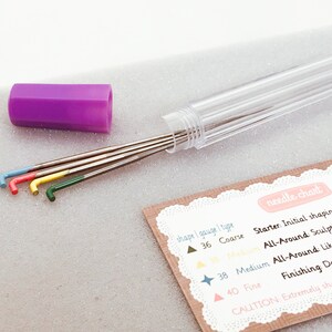 May include: Set of four sculpting tools with colored handles in a clear plastic tube. The tools are labeled with their gauge and type: 36 Coarse, 38 Medium, 40 Fine. The card also includes instructions for using the tools for sculpting.
