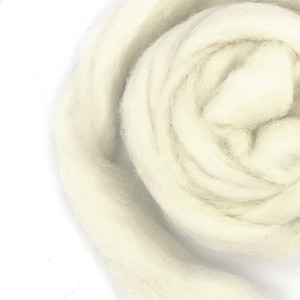 May include: A close-up of a white wool roving, a soft and fluffy fiber used for felting and spinning.