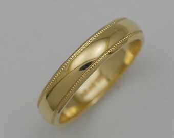 May include: A gold wedding band with a beaded edge.