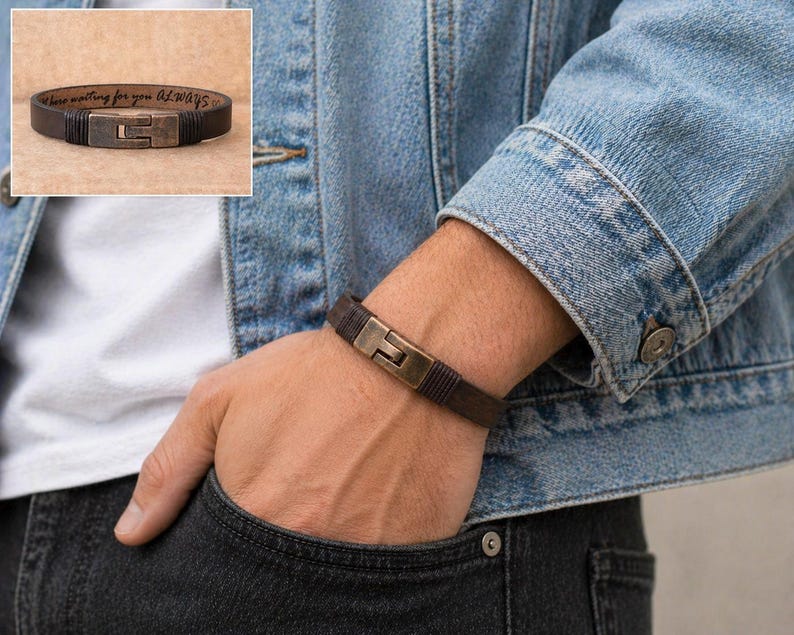 May include: A brown leather bracelet with a rectangular, bronze-colored clasp is shown on a wrist. The bracelet is worn with a denim jacket and a white shirt. The inset image shows the bracelet with the text "...here waiting for you Always..."