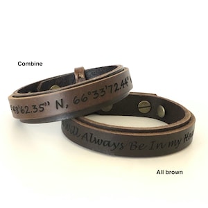 May include: Two brown leather bracelets with engraved text. One bracelet reads "48'62.35" N, 66°33'72.44" and the other reads "You Will Always Be In My Heart".