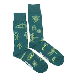 May include: A pair of teal blue socks with a pattern of yellow insects, including butterflies, beetles, and dragonflies. The socks have the text "FRIDAY SOCK CO." on the bottom.