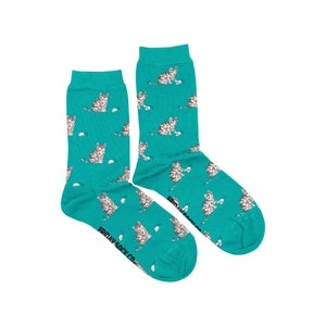 May include: A pair of teal blue socks with a pattern of grey tabby cats playing with white yarn balls. The socks have the text "FRIDAY SOCK CO." printed on the bottom of one sock.