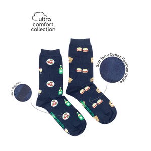 May include: A pair of navy blue socks with a picnic themed pattern. The socks feature images of sandwiches, wine glasses, and bottles of wine. The socks have a soft terry cotton footbed and arch support. The socks are labeled "FRIDAY SOCK CO."