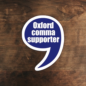 May include: A blue and white sticker with a speech bubble shape. The text inside the speech bubble reads "Oxford comma supporter".