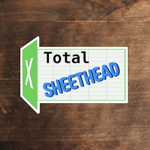 May include: A green and white sign with a large "X" and the text "Total Sheethead" in blue letters.
