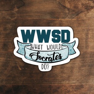 May include: A white sticker with the text "WWSD" in teal block letters above a banner that reads "WHAT WOULD Socrates DO?" in black script. The banner is light blue with a dotted pattern.