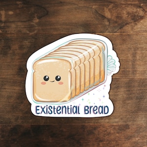 May include: A white sticker with a cartoon illustration of a loaf of bread with a smiling face. The bread is in a plastic bag and has the text "Existential Bread" below it.