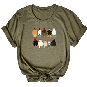 May include: A green t-shirt featuring a graphic of a line of chickens in different colours and breeds.
