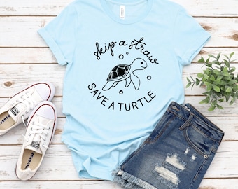 May include: Light blue t-shirt with a black graphic of a sea turtle and the text "skip a straw save a turtle".