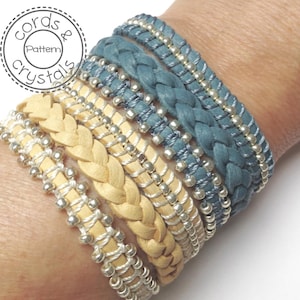 May include: A stack of braided leather bracelets with silver beads and a light blue and beige colour scheme. The bracelets are stacked on a person's wrist.