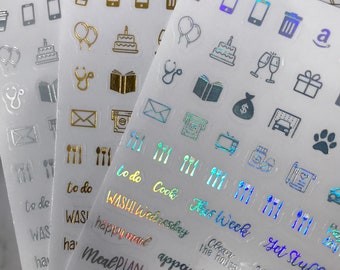 May include: A set of clear sticker sheets with various icons and text. The icons include a coffee cup, a phone, a trash can, balloons, a cake, a stethoscope, a book, an envelope, a money bag, a car, a paw print, a TV, a camera, and a notebook. The text includes "to do", "Cook", "This Week", "Get Stuff Done", "Clean the House", "Washi Wednesday", "Happy Mail", "Meal Plan", "Appointment", "Laundry Today", "Coffee Morning".