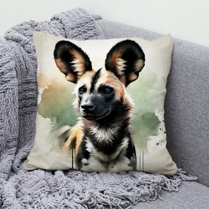 May include: A watercolor painting of a brown and black African wild dog with large ears. The dog is looking to the left of the image. The background is a light green watercolor wash.