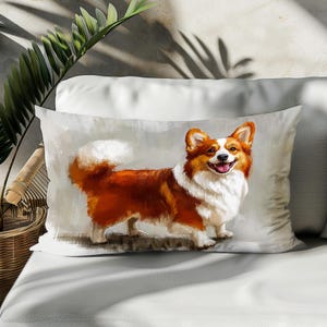 May include: A white pillow with a colorful illustration of a smiling corgi dog. The dog is brown and white with a fluffy tail.