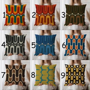 May include: Nine square throw pillows with retro wave patterns in various color schemes. Pillows feature designs in orange, red, green, blue, brown, and black. The pillows are square and appear to be made of a soft fabric.