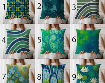 May include: Nine decorative cushions with diverse designs. The cushions feature patterns like geometric shapes, abstract swirls, and floral motifs. Colours include shades of blue, green, and white. The cushions are square-shaped and appear to be made of fabric.