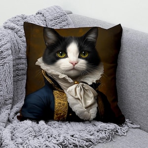 May include: A black and white cat wearing a blue and gold jacket with a white lace collar and a white bow tie. The cat is looking directly at the viewer with a serious expression.