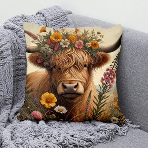 May include: A brown and white Highland cow with long, shaggy hair is wearing a crown of colorful flowers. The cow is looking at the camera with a gentle expression. The background is a field of green grass and wildflowers.