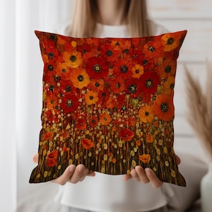 May include: Square cushion with a vivid floral design. The cushion displays a field of red and orange poppies with yellow highlights. The artwork has a textured, painted appearance, creating a warm and inviting aesthetic.