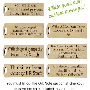 May include: A collection of custom wood gift notes with engraved messages of sympathy and support. The notes are rectangular with a rounded end and a hole for attachment. Text includes phrases like "Thinking of you" and "With our deepest sympathy."