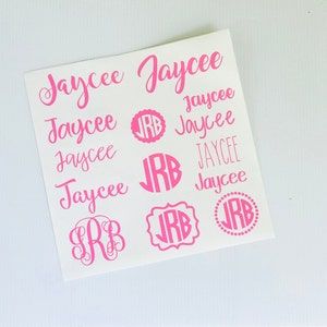 May include: A sheet of pink vinyl stickers with the name "Jaycee" written in cursive and a monogram "JRB" in various styles.