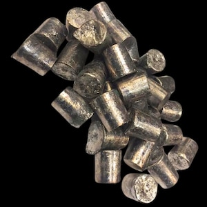 May include: A pile of silver-colored metal ingots, likely used for casting or smelting. The ingots are irregularly shaped and have a rough, textured surface.