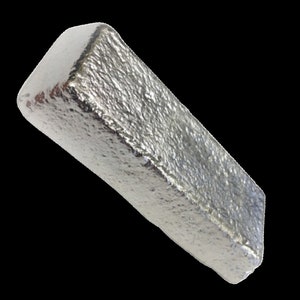 May include: A silver-colored metal bar with a rough, textured surface.