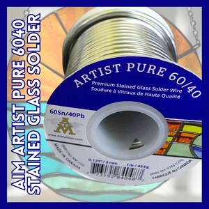 May include: A spool of silver-colored stained glass solder wire, labeled "Artist Pure 60/40 Premium Stained Glass Solder Wire Soudure à Vitraux de Haute Qualité 60Sn/40Pb". The spool is 1 lb (454 g) and is 0.125 inches (3 mm) in diameter. It is made in Canada.