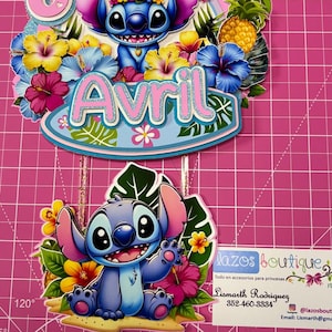 May include: A vibrant birthday cake topper with the character Stitch. The topper includes the number 6, the name "Avril", and floral decorations. The design is set against a pink background.