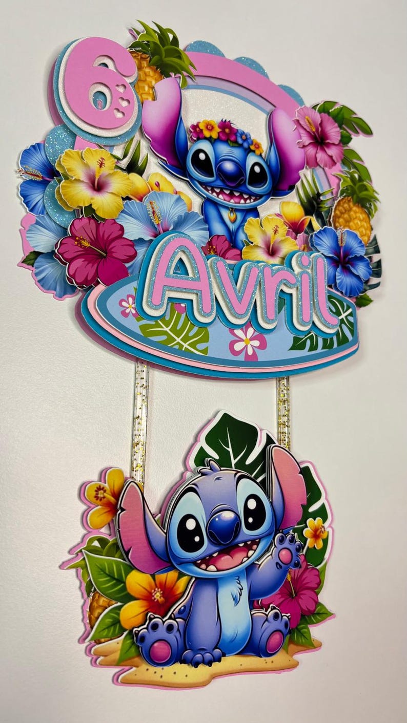 May include: A vibrant cake topper with a cartoon Stitch design, adorned with tropical flowers and the name "Avril". The number "6" is present, indicating a birthday celebration. The design is layered.