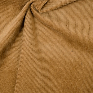 May include: Close-up of a brown corduroy fabric with a textured, ribbed surface.