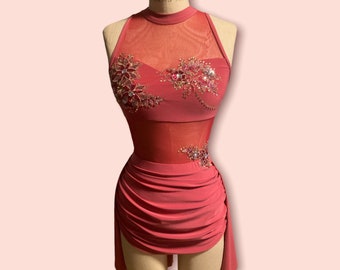 May include: A coral-colored dance costume with a halter neckline and a sheer mesh bodice. The bodice and skirt are embellished with floral beadwork. The skirt has a ruched design with a side slit. The costume is displayed on a mannequin.