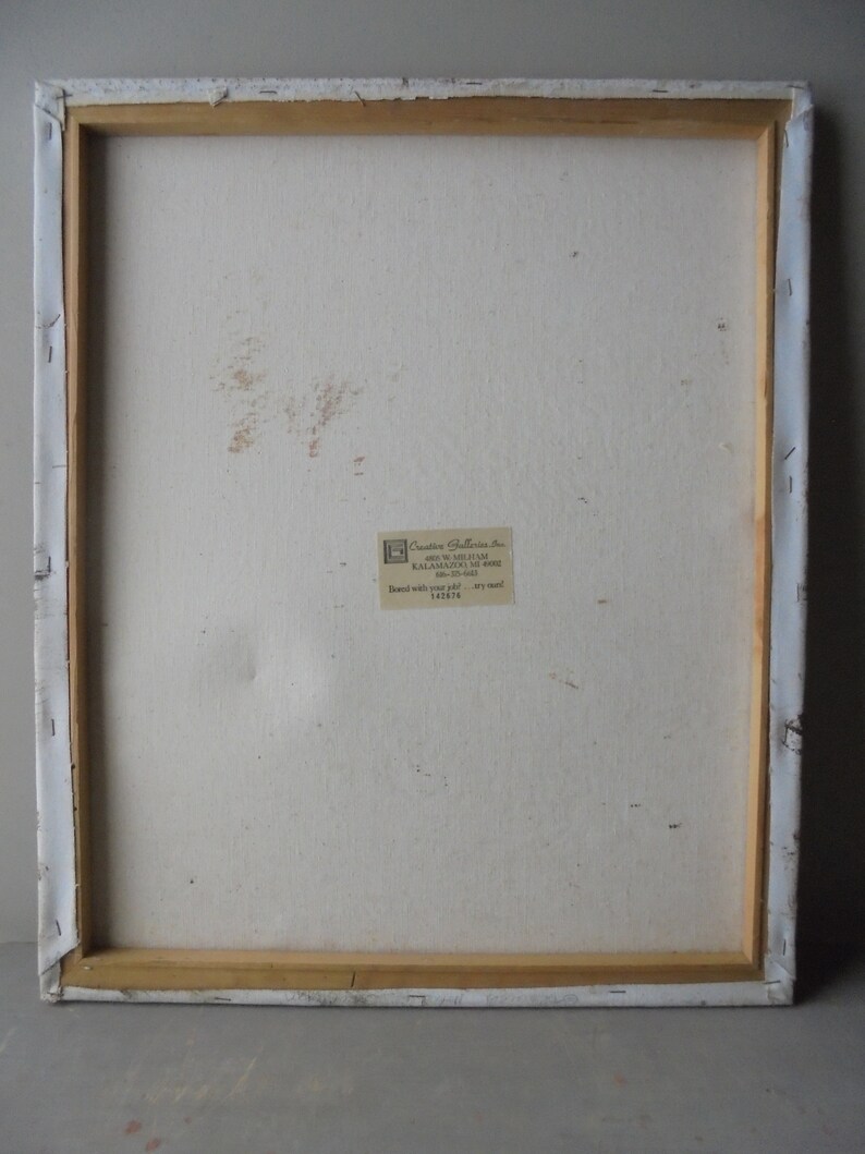 May include: The back of a stretched canvas painting with a white background and a small label that reads "Creative Galleries, Inc. 400 W. Michigan Ave. Kalamazoo, MI 49007 616-373-6441  Brand with your job - try our 182876"