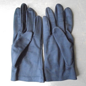 Peut inclure: Une paire de gants bleu fonc&eacute; en tissu lisse.