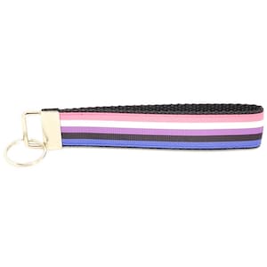 May include: A black and white striped key chain with a gold key ring. The stripes are pink, white, blue, black, and purple.