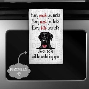 May include: White kitchen towel with a black Labrador illustration and the text "Every snack you make, Every meal you bake, Every bite you take, JACKSON will be watching you."