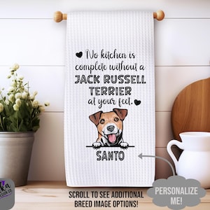 May include: White kitchen towel with a waffle weave texture, featuring a Jack Russell Terrier graphic and the text "No kitchen is complete without a Jack Russell Terrier at your feet." The dog's name, "SANTO," is below the image.