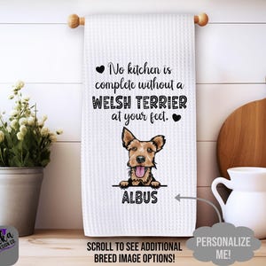 May include: White waffle-weave kitchen towel with a Welsh Terrier graphic. The towel has the text "No kitchen is complete without a Welsh Terrier at your feet." The dog's name, "Albus," is below the graphic.